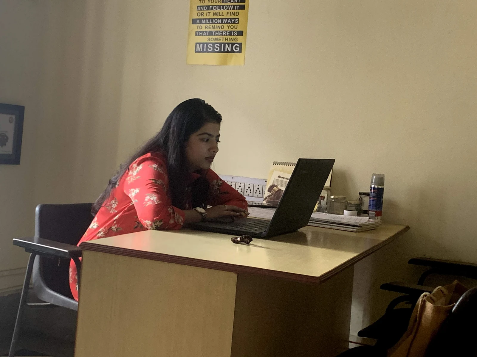 A colleague working at a laptop, from the Webbies archive