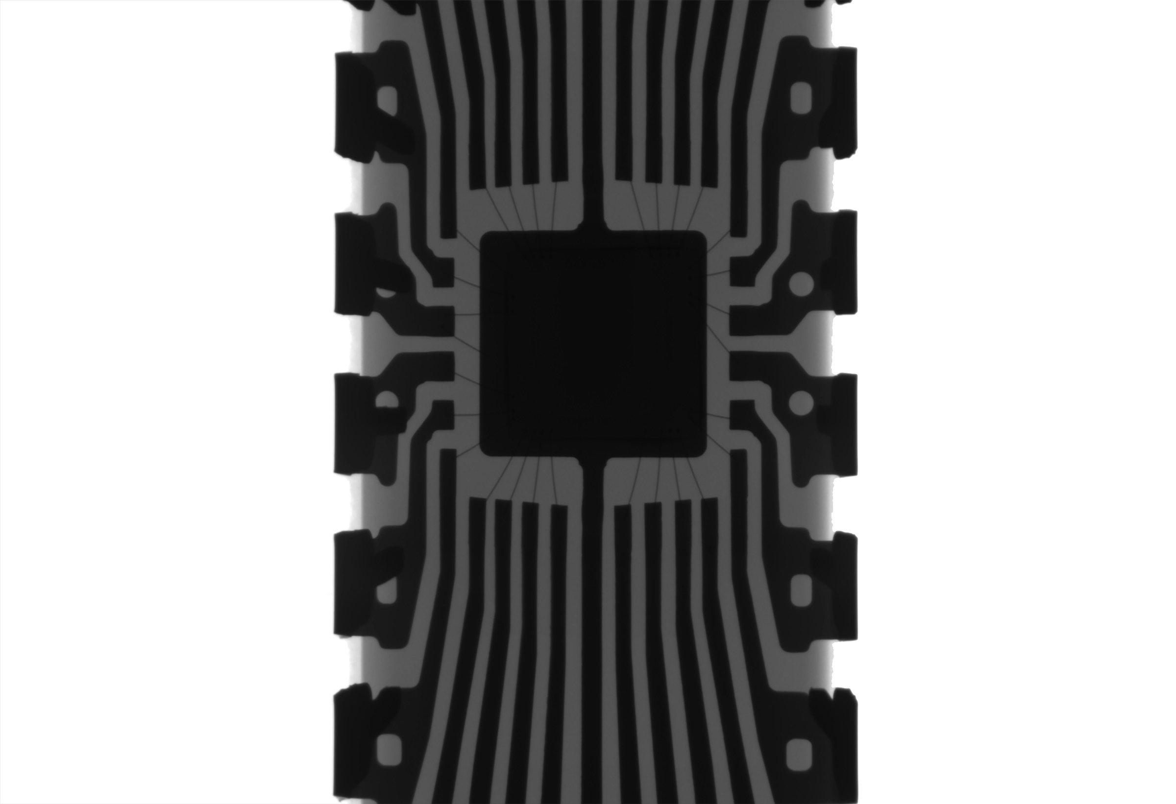 A monochrome X-ray photograph revealing the internal connections of an Arduino chip