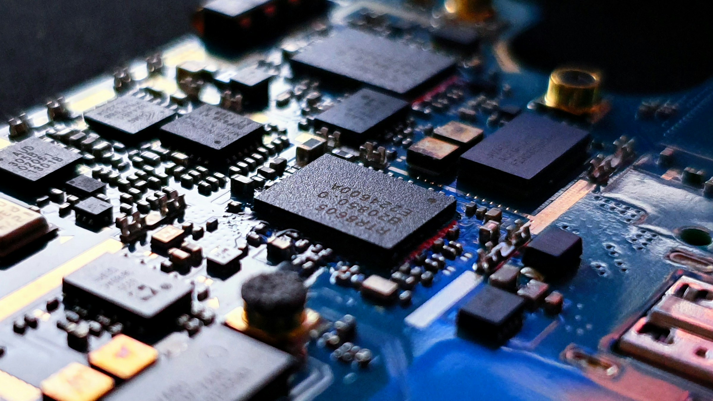 A macro photograph of the chips and connections on a physical circuit board