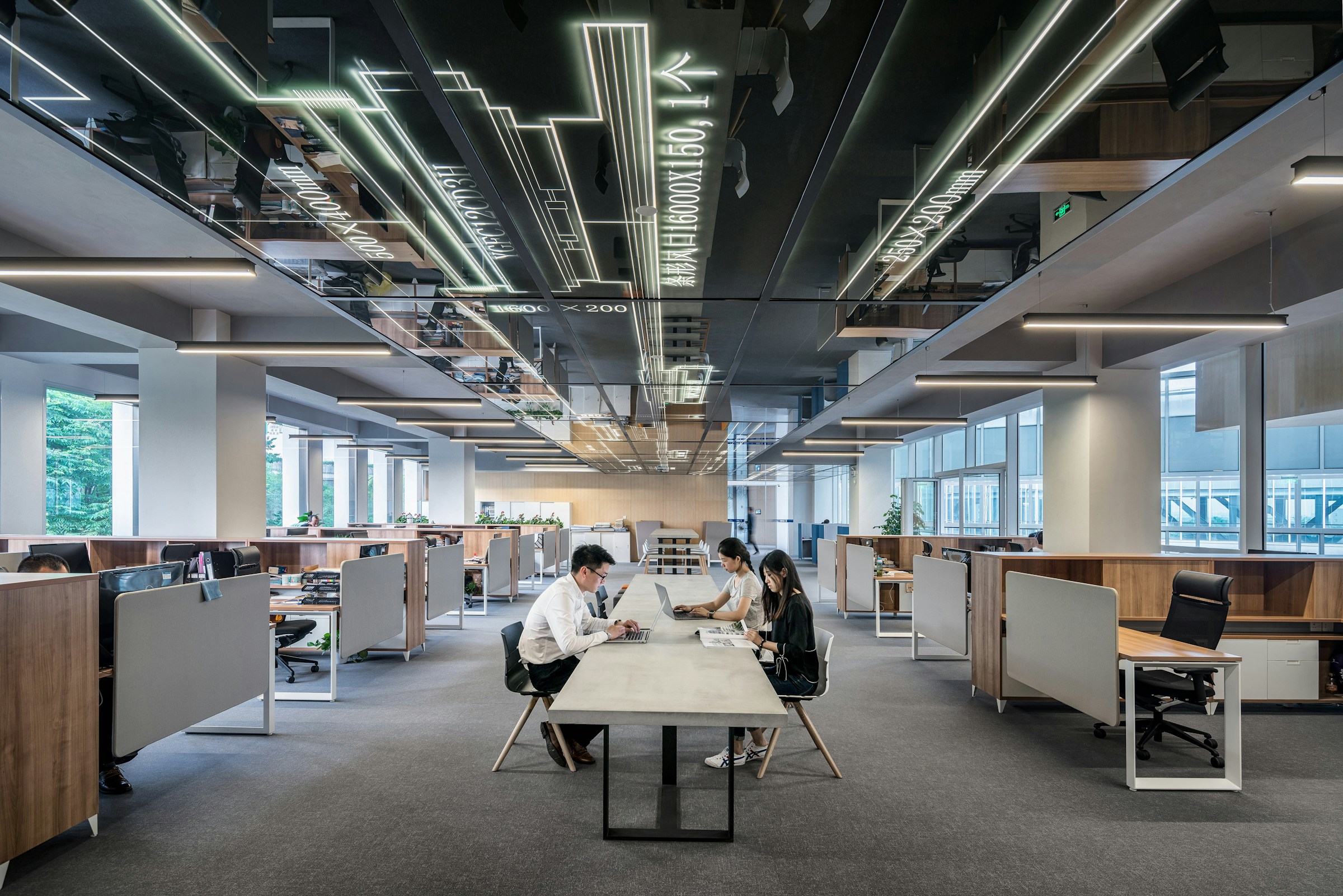 People collaborating around a shared table in a contemporary open studio
