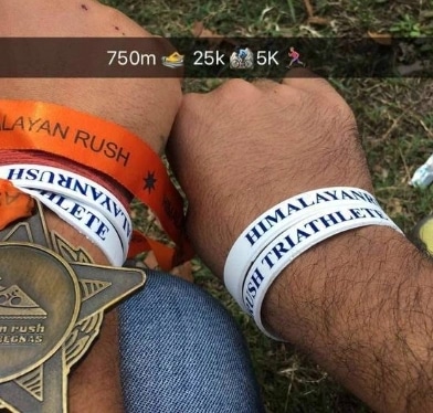 Original Himalayan Rush triathlete finisher wristbands and medal photograph